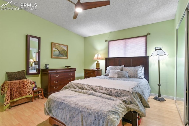 1018 Fontmore Rd Unit D, Colorado Springs, CO 80904 - bedroom featuring light wood-style flooring, a textured ceiling, a ceiling fan, a closet, and baseboards