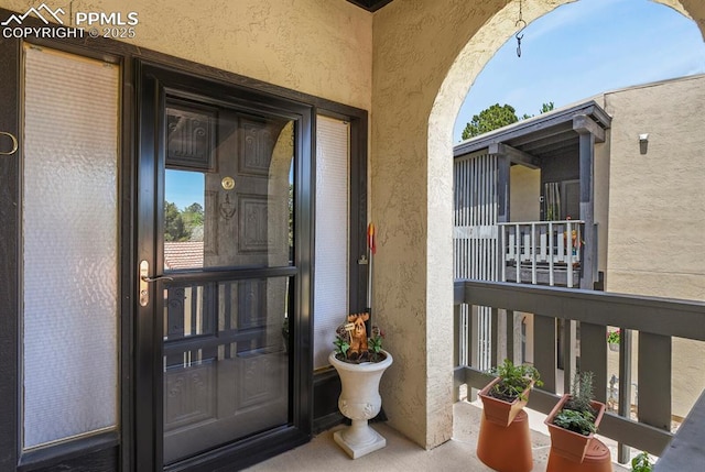 1018 Fontmore Rd Unit D, Colorado Springs, CO 80904 - doorway to property featuring stucco siding and a balcony