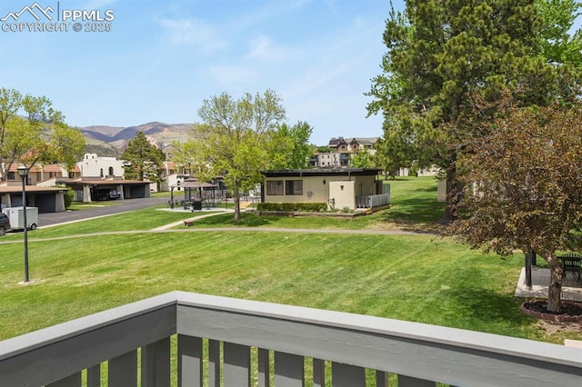 1018 Fontmore Rd Unit D, Colorado Springs, CO 80904 - view of green lawn featuring a mountain view, a balcony, and a residential view