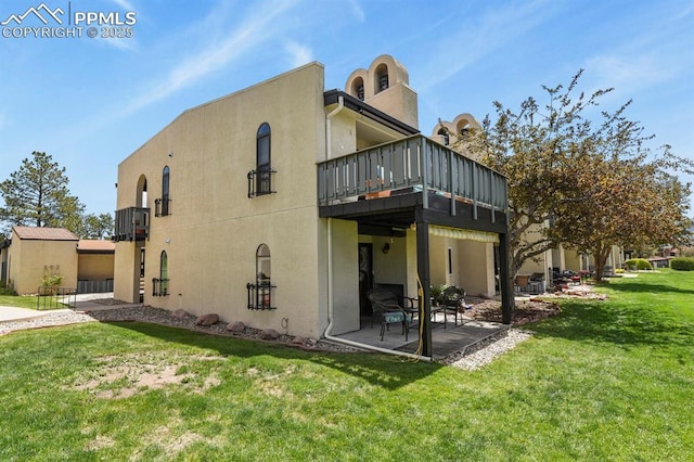 1018 Fontmore Rd Unit D, Colorado Springs, CO 80904 - rear view of property featuring a yard, stucco siding, and a patio