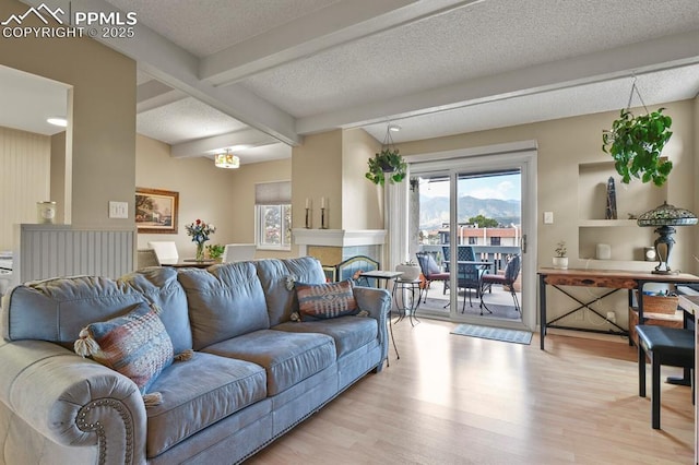 1018 Fontmore Rd Unit D, Colorado Springs, CO 80904 - living room with plenty of natural light, wood finished floors, beam ceiling, and a textured ceiling