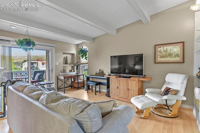 1018 Fontmore Rd Unit D, Colorado Springs, CO 80904 - living room featuring beam ceiling, light wood-style flooring, a textured ceiling, and baseboards