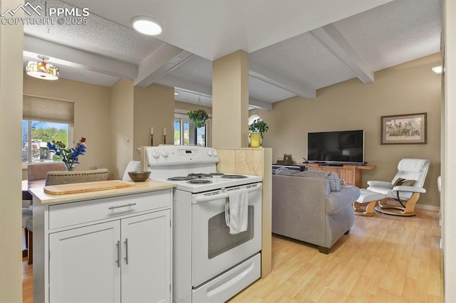1018 Fontmore Rd Unit D, Colorado Springs, CO 80904 - kitchen featuring white electric stove, beamed ceiling, light wood-style flooring, open floor plan, and white cabinetry