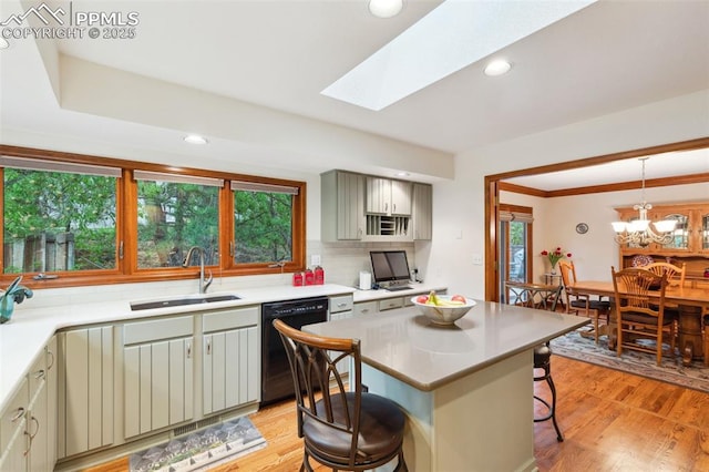 720 Popes Valley Dr, Colorado Springs, CO 80919 - kitchen featuring black dishwasher, a sink, a kitchen breakfast bar, plenty of natural light, and recessed lighting