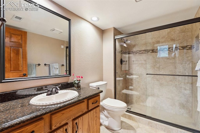 720 Popes Valley Dr, Colorado Springs, CO 80919 - full bath with toilet, a shower stall, vanity, a textured wall, and tile patterned floors
