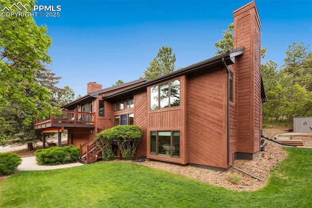 720 Popes Valley Dr, Colorado Springs, CO 80919 - rear view of house featuring a chimney, a lawn, a deck, and stairs