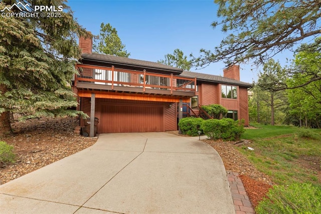 720 Popes Valley Dr, Colorado Springs, CO 80919 - chalet / cabin with a chimney, an attached garage, concrete driveway, and a front yard