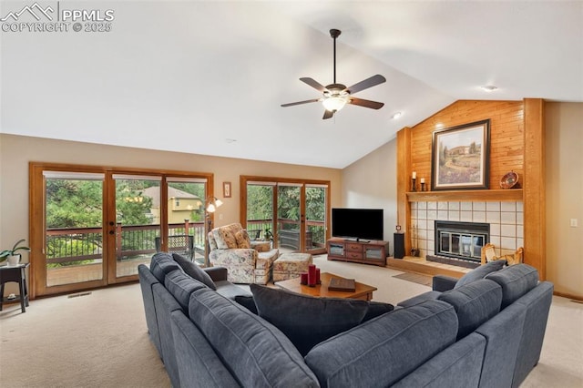 720 Popes Valley Dr, Colorado Springs, CO 80919 - living room with light colored carpet, vaulted ceiling, a ceiling fan, a tiled fireplace, and french doors