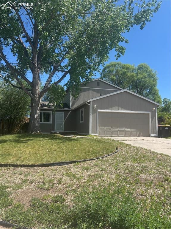 4477 Berryknoll Dr, Colorado Springs, CO 80916 - view of front facade with a front yard, a garage, and concrete driveway