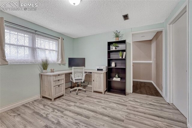 7108 Chippewa Rd, Colorado Springs, CO 80915 - office with light wood finished floors and a textured ceiling