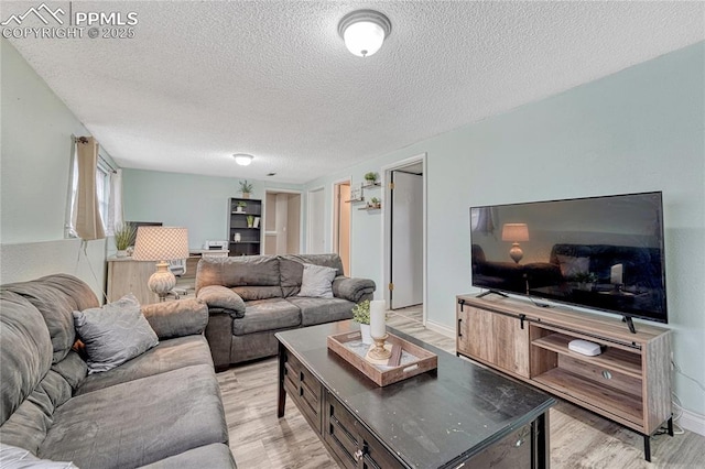 7108 Chippewa Rd, Colorado Springs, CO 80915 - living area featuring a textured ceiling and light wood-style floors