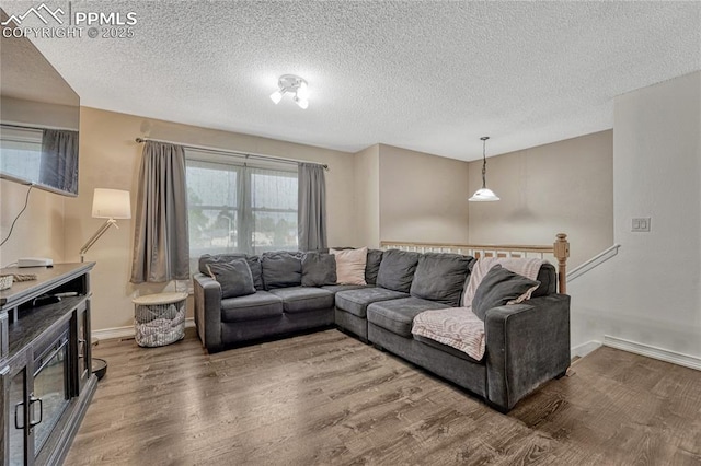7108 Chippewa Rd, Colorado Springs, CO 80915 - living room with wood finished floors and a textured ceiling