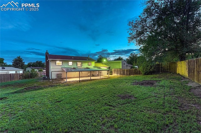 7108 Chippewa Rd, Colorado Springs, CO 80915 - yard at dusk featuring a fenced backyard