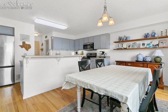7711 Menagerie Ln, Colorado Springs, CO 80923 - dining space with light wood-type flooring and baseboards