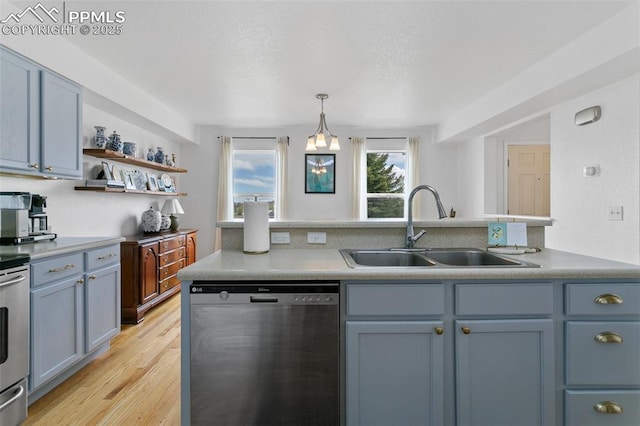 7711 Menagerie Ln, Colorado Springs, CO 80923 - kitchen featuring dishwasher, a sink, light wood-type flooring, open shelves, and light countertops