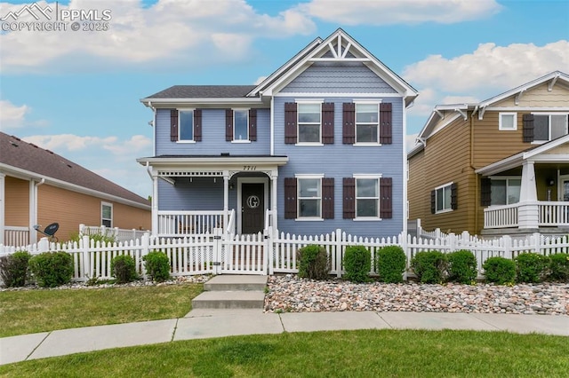 7711 Menagerie Ln, Colorado Springs, CO 80923 - view of front facade featuring covered porch and a fenced front yard