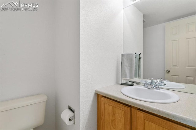 7711 Menagerie Ln, Colorado Springs, CO 80923 - half bathroom featuring toilet and vanity