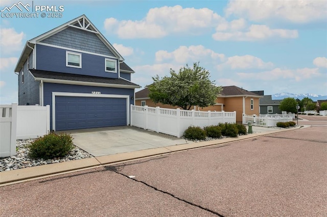 7711 Menagerie Ln, Colorado Springs, CO 80923 - view of front of house featuring an attached garage, driveway, and a fenced front yard
