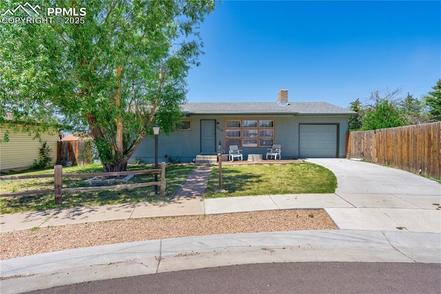 3510 Jon St, Colorado Springs, CO 80907 - single story home featuring concrete driveway, an attached garage, and a chimney