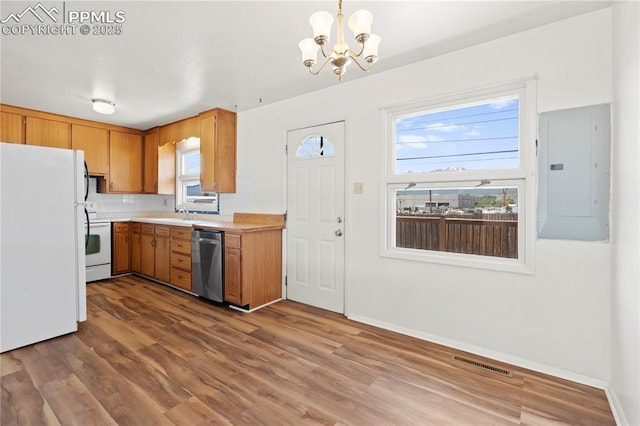 3510 Jon St, Colorado Springs, CO 80907 - kitchen with white appliances, electric panel, a chandelier, wood finished floors, and light countertops