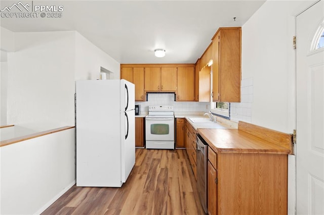 3510 Jon St, Colorado Springs, CO 80907 - kitchen featuring white appliances, light wood finished floors, brown cabinetry, and backsplash