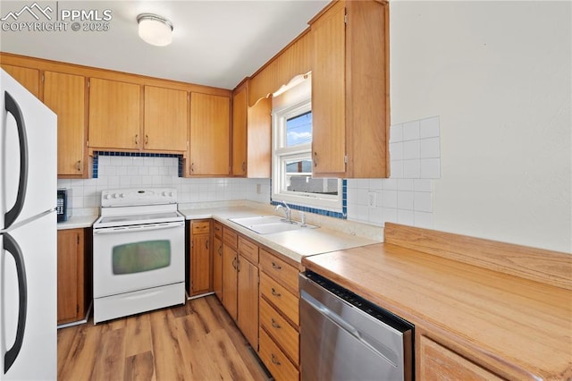 3510 Jon St, Colorado Springs, CO 80907 - kitchen featuring white appliances, a sink, light countertops, and backsplash