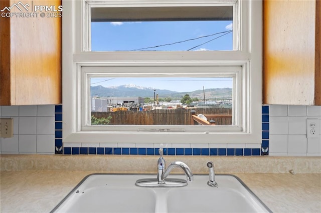 3510 Jon St, Colorado Springs, CO 80907 - detailed view of light countertops, decorative backsplash, mountains, and a sink