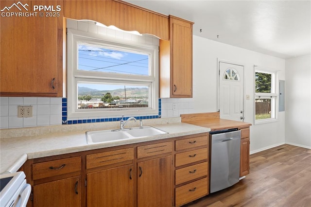 3510 Jon St, Colorado Springs, CO 80907 - kitchen featuring stainless steel dishwasher, a sink, wood finished floors, and tasteful backsplash