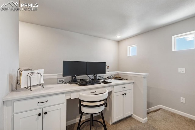 10671 Larimar Pt, Colorado Springs, CO 80905 - home office with built in desk, light carpet, and baseboards