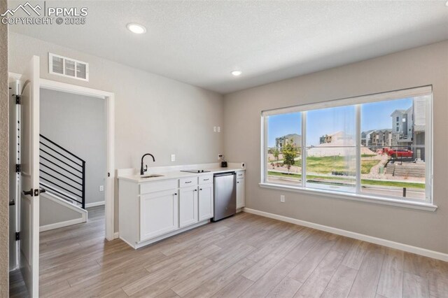 10671 Larimar Pt, Colorado Springs, CO 80905 - kitchen with light wood-type flooring, light countertops, refrigerator, baseboards, and recessed lighting