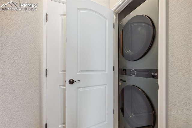 10671 Larimar Pt, Colorado Springs, CO 80905 - laundry area featuring estacked washer and dryer and a textured wall