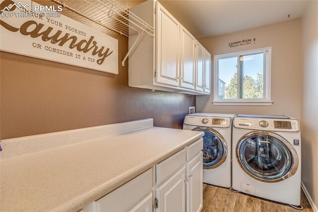 14915 Gleneagle Dr, Colorado Springs, CO 80921 - washroom featuring cabinet space, washer and dryer, and light wood-style flooring