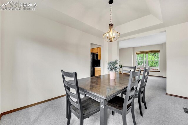6390 Moccasin Pass Ct, Colorado Springs, CO 80919 - dining room with a chandelier, baseboards, and light colored carpet