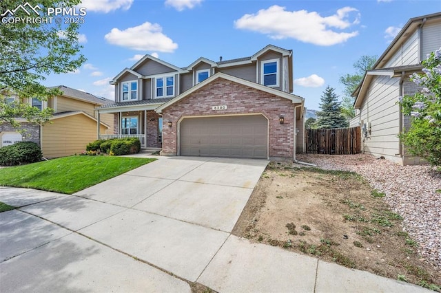 6390 Moccasin Pass Ct, Colorado Springs, CO 80919 - traditional home featuring brick siding, a garage, concrete driveway, and covered porch