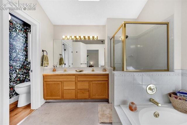 6390 Moccasin Pass Ct, Colorado Springs, CO 80919 - bathroom featuring a garden tub, a shower stall, double vanity, and toilet