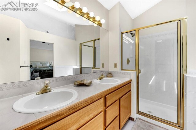 6390 Moccasin Pass Ct, Colorado Springs, CO 80919 - ensuite bathroom with lofted ceiling, a shower stall, and double vanity