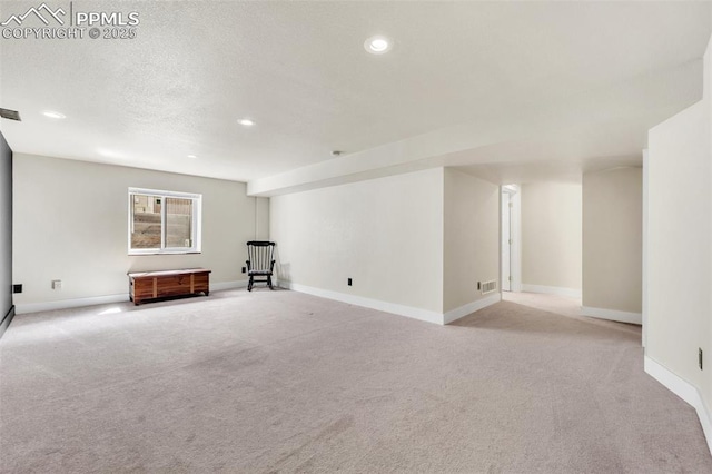 6390 Moccasin Pass Ct, Colorado Springs, CO 80919 - below grade area with light carpet, recessed lighting, baseboards, and a textured ceiling