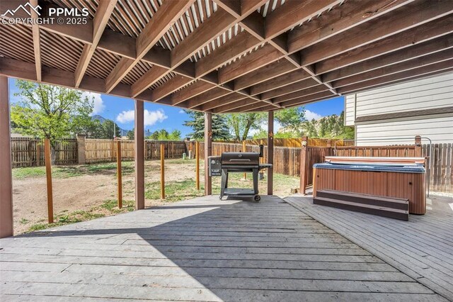 6390 Moccasin Pass Ct, Colorado Springs, CO 80919 - wooden terrace with a hot tub, a fenced backyard, and a grill