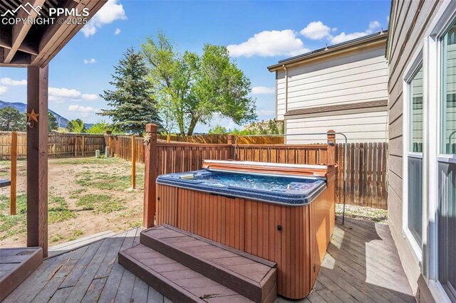6390 Moccasin Pass Ct, Colorado Springs, CO 80919 - deck featuring a hot tub and a fenced backyard