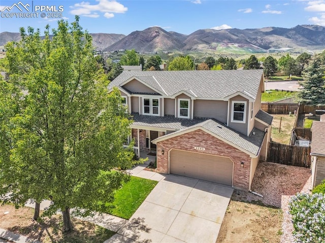 6390 Moccasin Pass Ct, Colorado Springs, CO 80919 - view of front of property featuring brick siding, driveway, a garage, and a mountain view