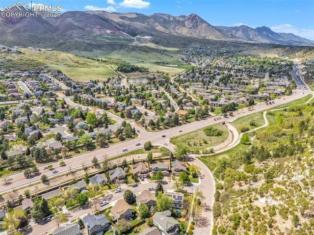 6390 Moccasin Pass Ct, Colorado Springs, CO 80919 - aerial view of property's location featuring mountains and nearby suburban area