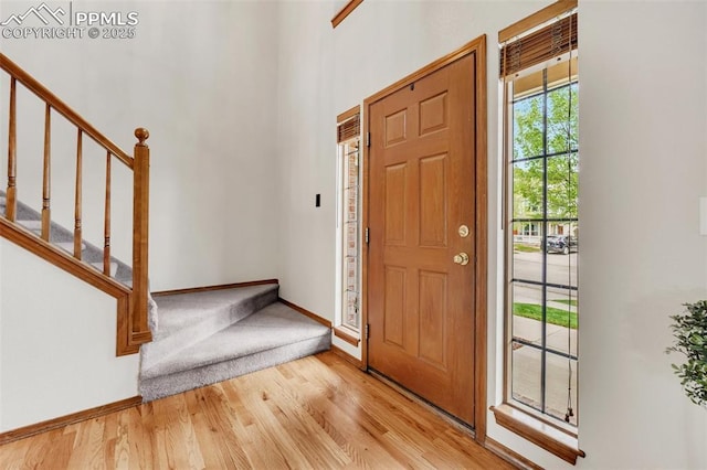 6390 Moccasin Pass Ct, Colorado Springs, CO 80919 - foyer entrance featuring baseboards, light wood finished floors, and stairs