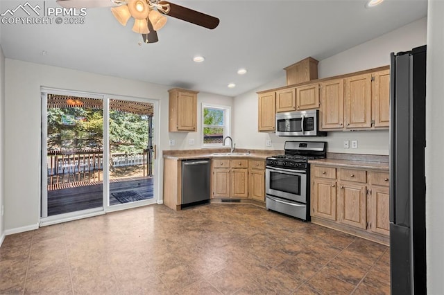 4686 Gray Fox Hts, Colorado Springs, CO 80922 - kitchen featuring appliances with stainless steel finishes, a sink, light brown cabinetry, ceiling fan, and lofted ceiling