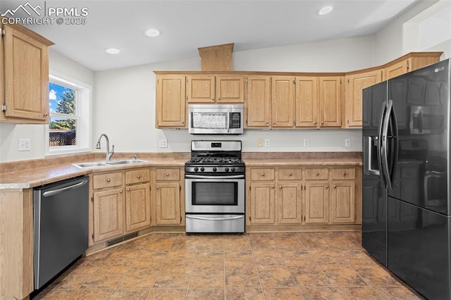 4686 Gray Fox Hts, Colorado Springs, CO 80922 - kitchen with stainless steel appliances, a sink, light brown cabinetry, lofted ceiling, and light countertops