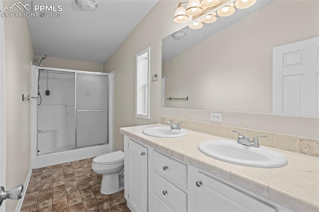 4686 Gray Fox Hts, Colorado Springs, CO 80922 - bathroom featuring an enclosed shower, double vanity, and toilet
