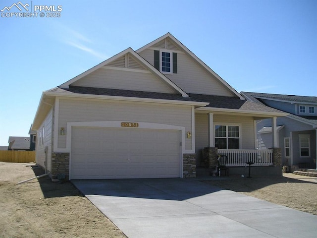 10531 Ross Lake Dr, Peyton, CO 80831 - craftsman inspired home featuring stone siding, concrete driveway, covered porch, and a garage