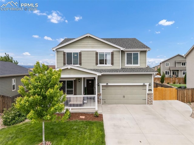 10140 Seawolf Dr, Colorado Springs, CO 80925 - view of front facade with a porch, an attached garage, concrete driveway, a shingled roof, and stone siding
