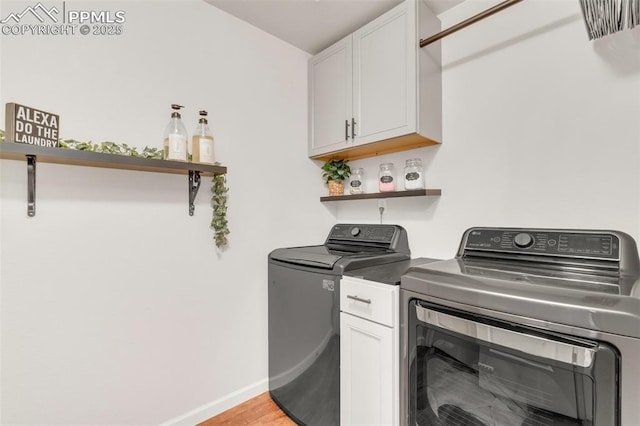 10140 Seawolf Dr, Colorado Springs, CO 80925 - washroom featuring washing machine and clothes dryer, cabinet space, baseboards, and light wood finished floors