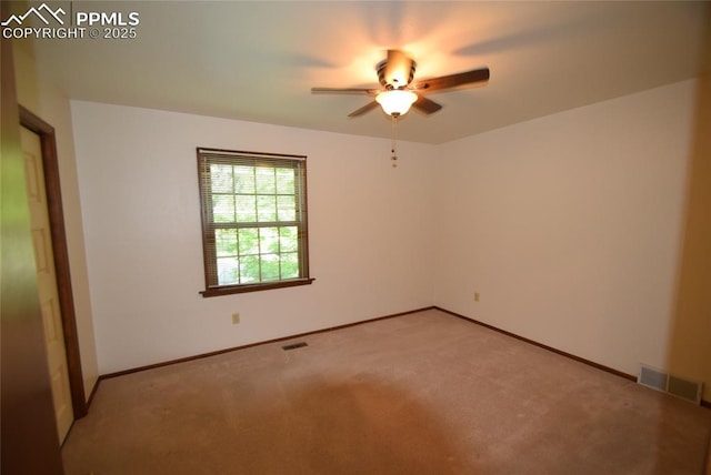 unfurnished room featuring ceiling fan, light colored carpet, and baseboards