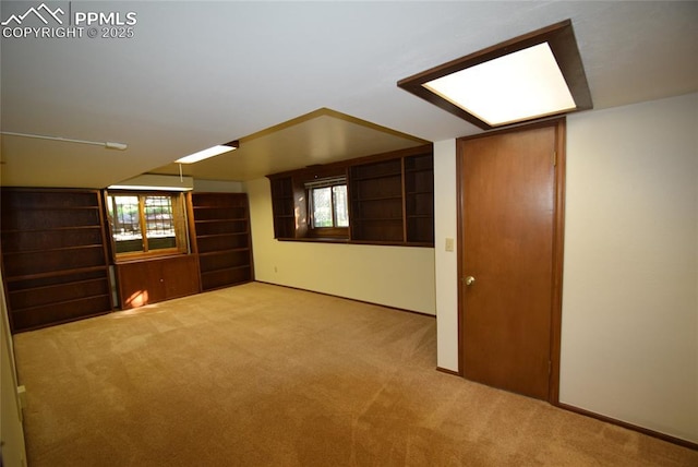 carpeted empty room featuring baseboards